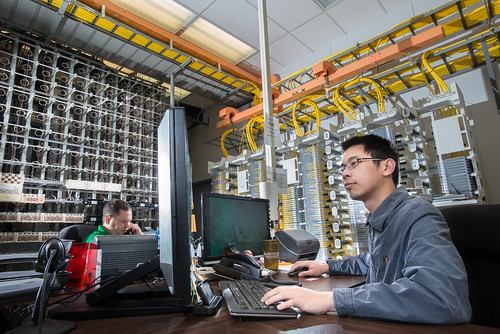 Workers monitor control stations at Pine Net Telephone and internet stations for the communications and broadband systems in Broken Bow, OK.