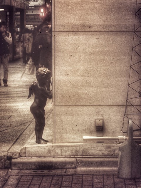 Cupid aiming at street retouched with Snapseed