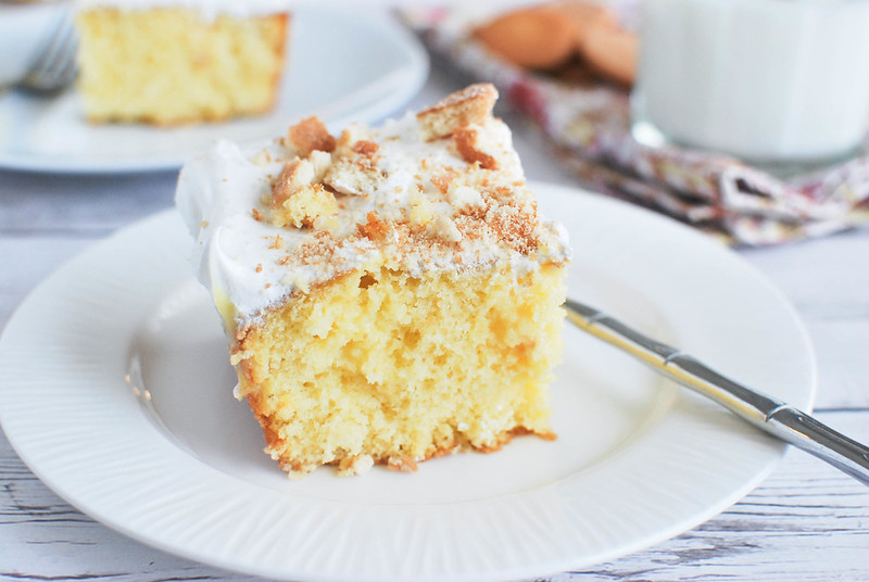 Banana Pudding Poke Cake - super delicious cake that starts with a boxed mix and is filled with banana pudding! Tastes like an old-fashioned layered banana pudding!