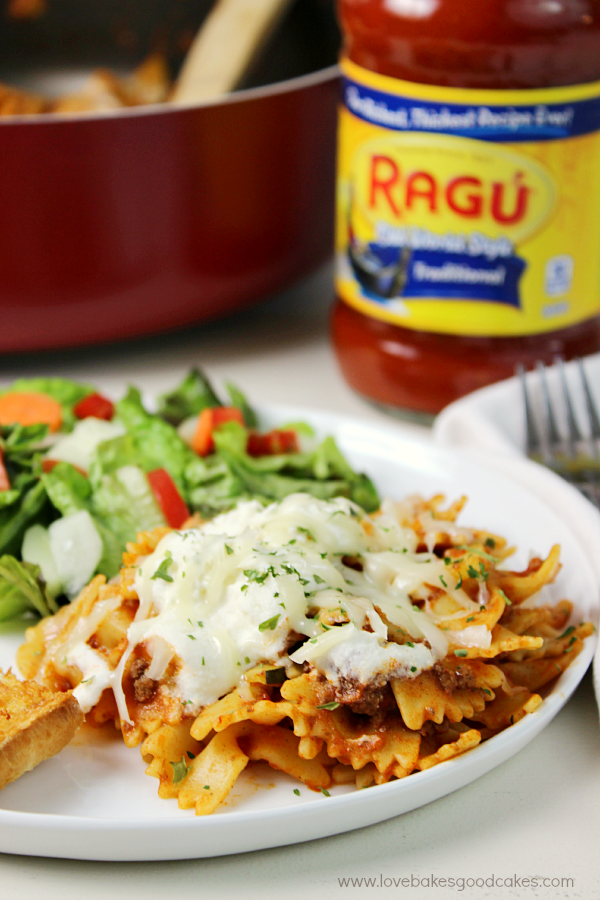Weeknight Sausage & Zucchini Skillet Lasagna on a white plate with a jar of Ragu.