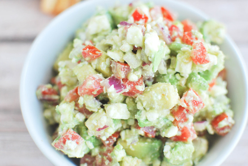 Avocado Feta Salsa - avocado, tomato, feta cheese, and red onion tossed in a garlic vinaigrette. Serve with pita chips for the perfect party snack!
