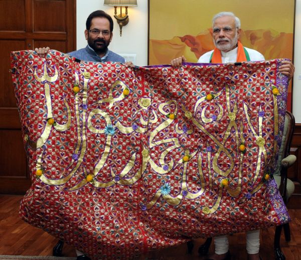 Prime Minister, Narendra Modi handing over the "Chaadar" to be offered at Dargah of Khwaja Moinuddin Chishti, Ajmer Sharif, to the Minister of State for Minority Affairs and Parliamentary Affairs, Mukhtar Abbas Naqvi, in New Delhi on April 21, 2015.
