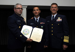 Master Chief Petty Officer of the Coast Guard Steven Cantrell, Petty Officer 2nd Class Giacomo Terrizzi and Adm. Paul Zukunft, Coast Guard commandant, pose for a photo during the 2014 Coast Guard Enlisted Persons of the Year Banquet at Joint Base Anacostia-Bolling in Washington, D.C., May 7, 2015. During the ceremony, Terrizzi was recognized as the Enlisted Person of the Year - Active-Duty Component, an honor that comes with a meritorious advancement - in Terrizzi's case, an advancement from petty officer third class to petty officer second class. (U.S. Coast Guard photo by Chief Petty Officer Kyle Niemi)