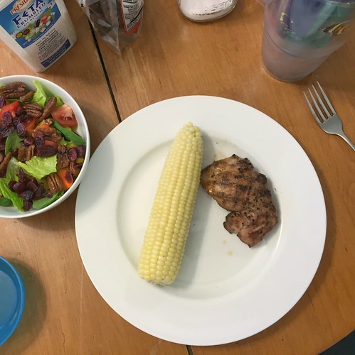 grilled chicken thighs, corn on the cob, salad
