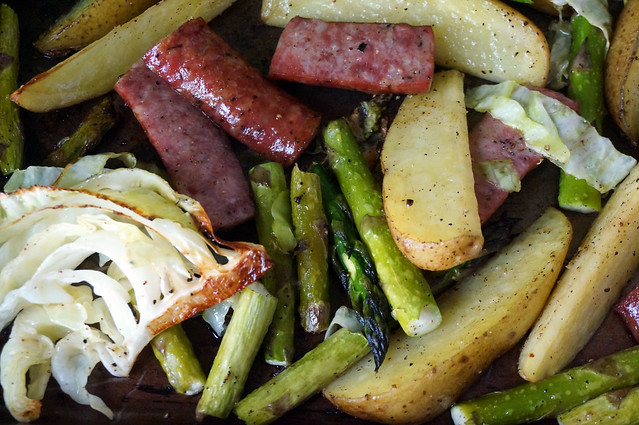 Closeup on roasted vegetables; most prominent is a sliver of cabbage that is deeply browned and looks completely enticing