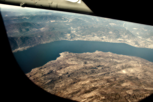 landscape scenic airplane jet aircraft flying window wing water lake mountains hills bc canada peachland okanagan blue brown grey gray