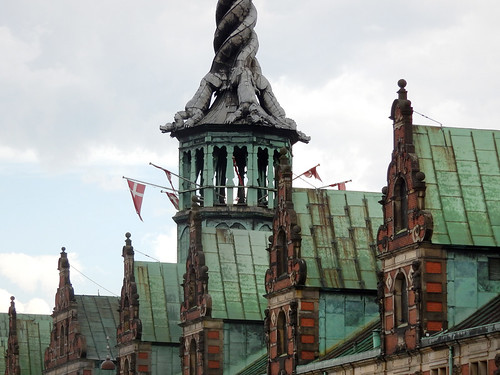 A twisted dragon steeple building all have weathered copper (verdigris) roofs in Copenhagen, Denmark
