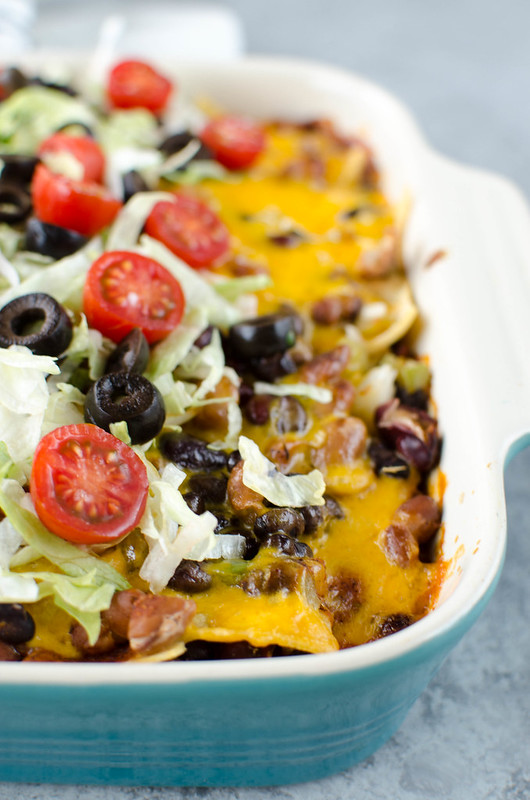 Three Bean Enchilada Casserole - black beans, pinto beans, and kidney beans layered with corn tortillas, enchilada sauce, and cheese. An easy meatless meal the whole family will love! 