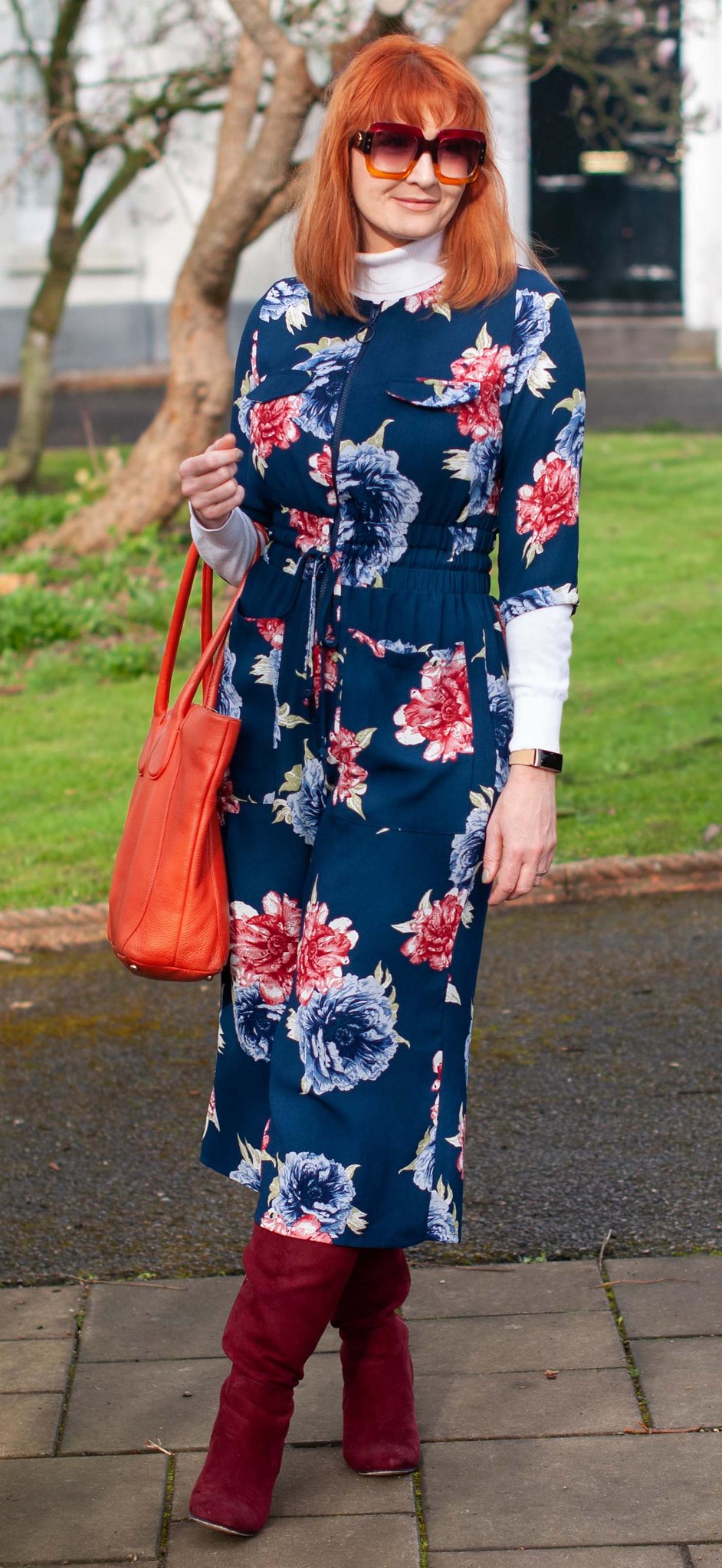 Fashion Over 40: How to Layer a Jumpsuit in Spring (and a Touch of the Elton John) \ navy and red floral jumpsuit \ white roll neck sweater \ burgundy slouch boots \ navy pinstripe coat \ Elton John-style sunglasses | Not Dressed As Lamb style blog