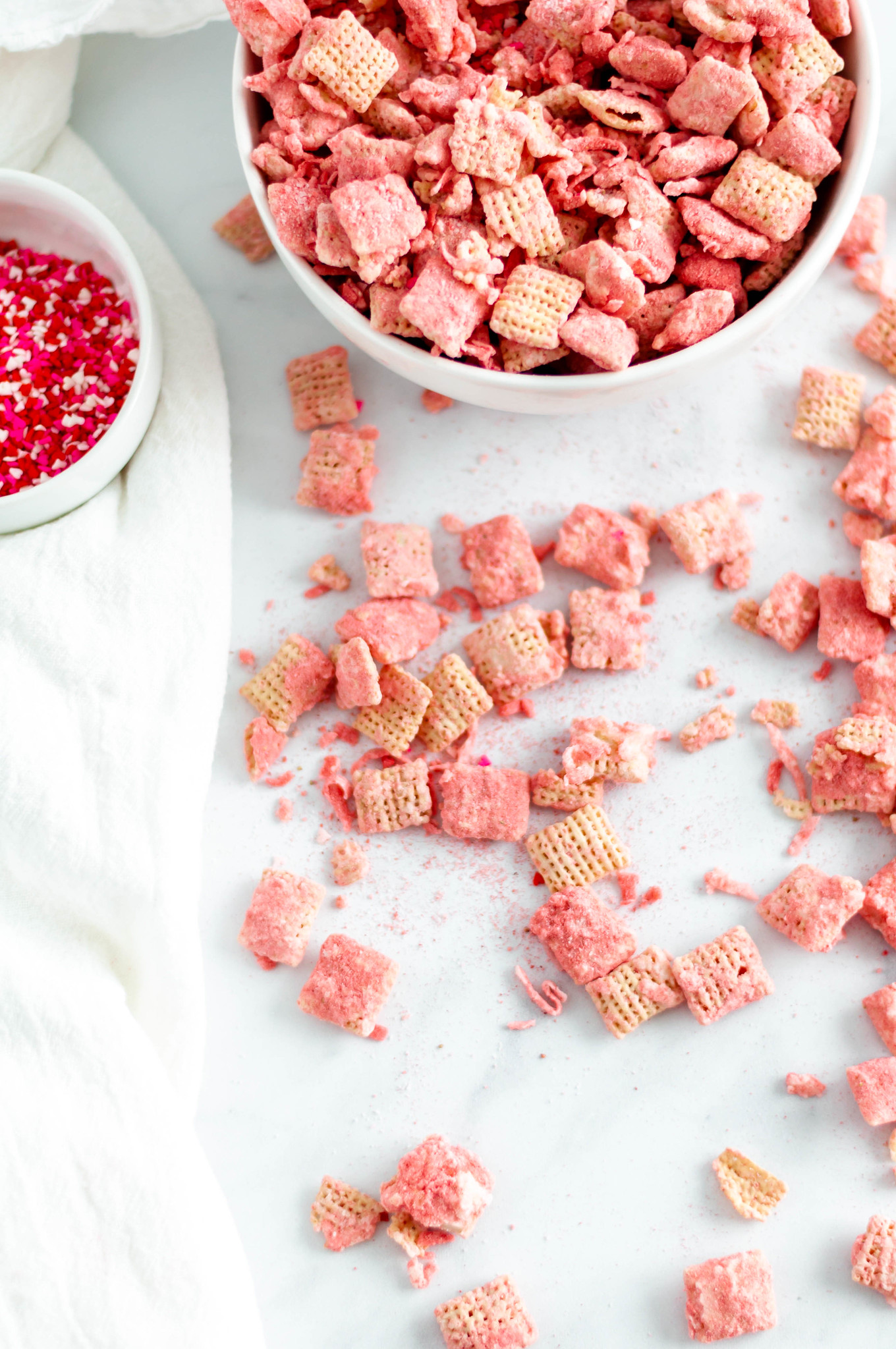 Make your Valentines Day festive with this Coconut Strawberry Puppy Chow. White chocolate, freeze dried strawberries & coconut are such a sweet combination.