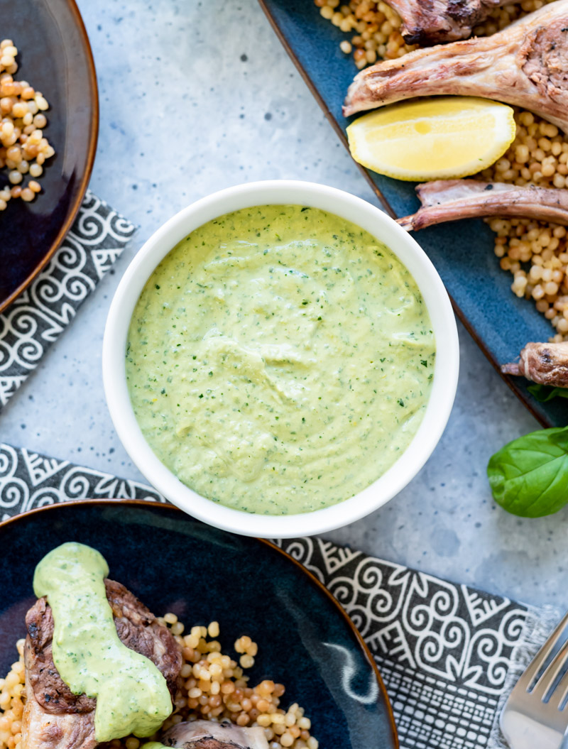 white bowl filled with green herbed tahini sauce