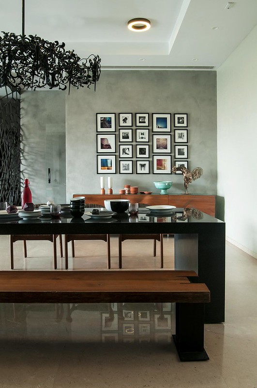 A gallery wall behind the dining area in this modern colour infused home