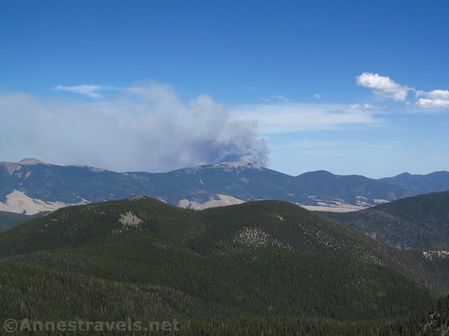 Smoke billows from behind Touch-Me-Not Mountain in Carson National Forest, New Mexico