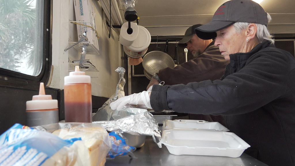 Saralyn Harder serving food inside the Jarheadz BBQ food truck