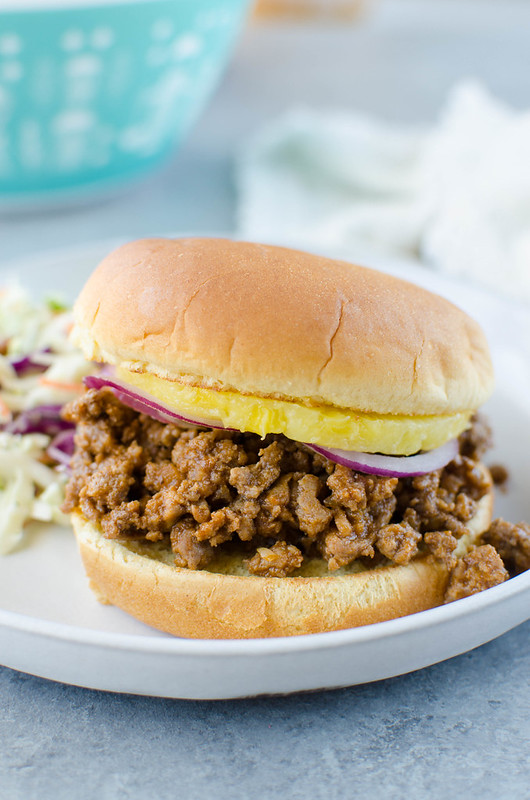 Hawaiian Sloppy Joes - bacon, ground beef, and veggies in a pineapple sweet and sour sauce. Served on a toasted bun with pineapple rings on top! A delicious 30 minute weeknight meal!