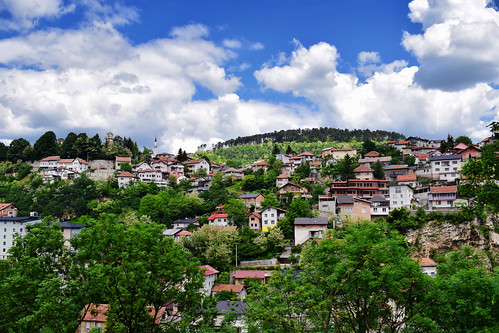 landscapes mountains clouds sky view vista buildings architecture cityviews trees foliage sarajevo bosniaandherzegovina balkans travel