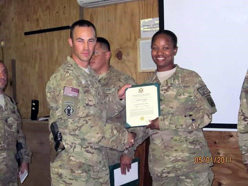 Amber Grant is pictured receiving a promotion certificate from a superior
