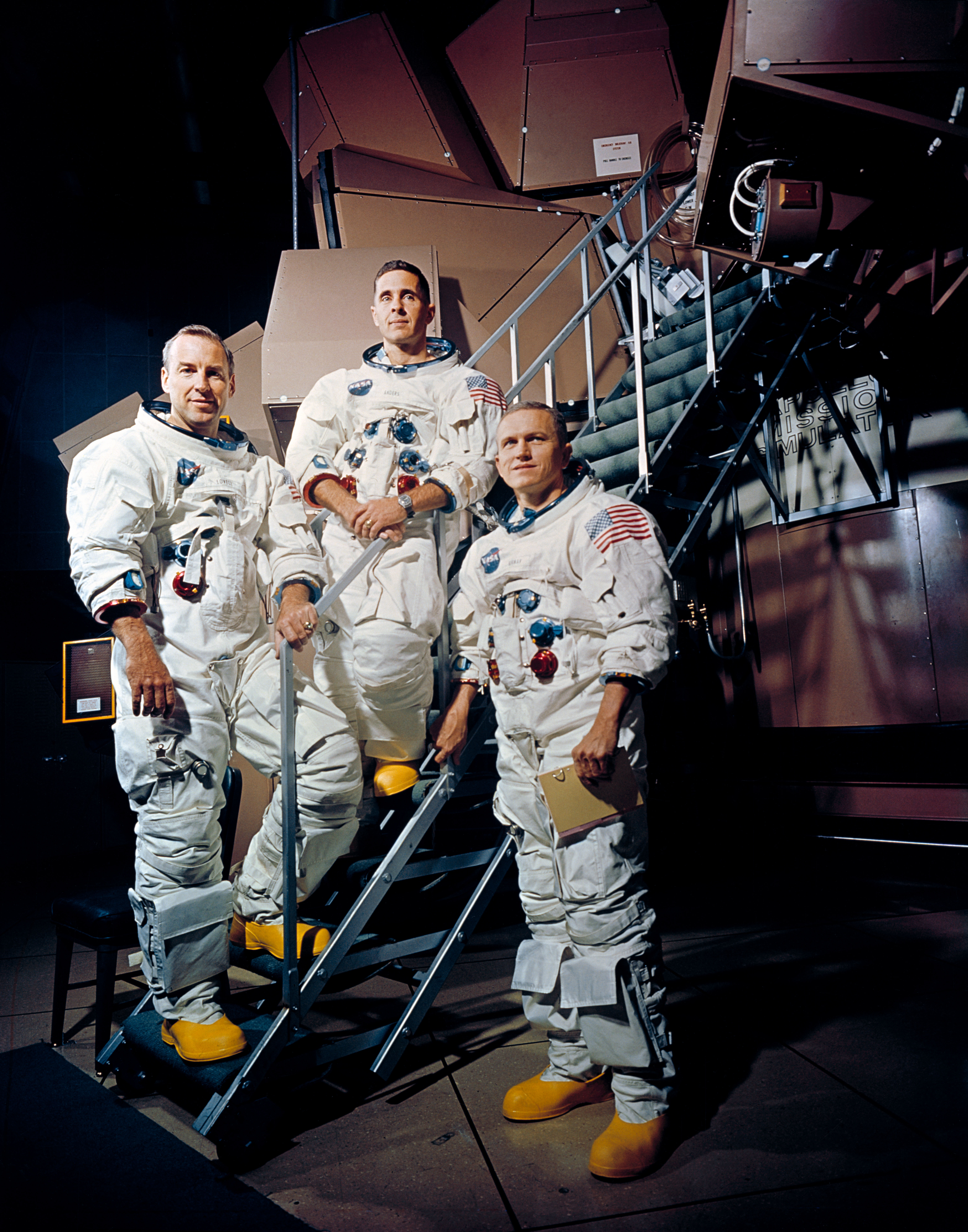 Apollo 8 crew is photographed posing on a Kennedy Space Center (KSC) simulator in their space suits. From left to right are: James A. Lovell Jr., William A. Anders, and Frank Borman. Photo taken on November 22, 1968.