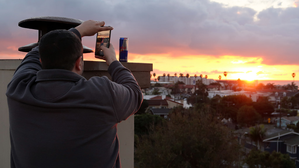 Jordan King taking a photo of his Red Bull can