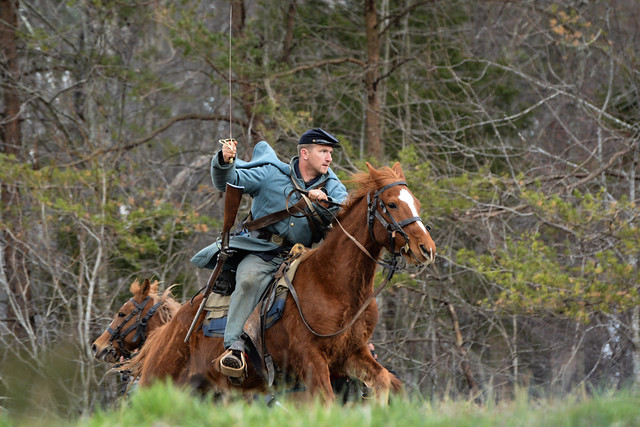 A living historian dressed as a Union Cavalryman rides across the battlefield at Sailor's Creek.