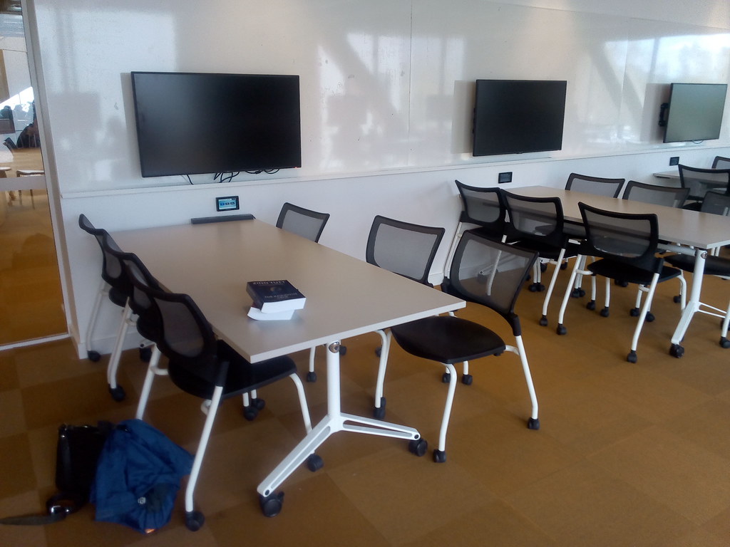 Wall mounted LCD screens and desks on wheels at ANU Marie Reay Teaching Centre