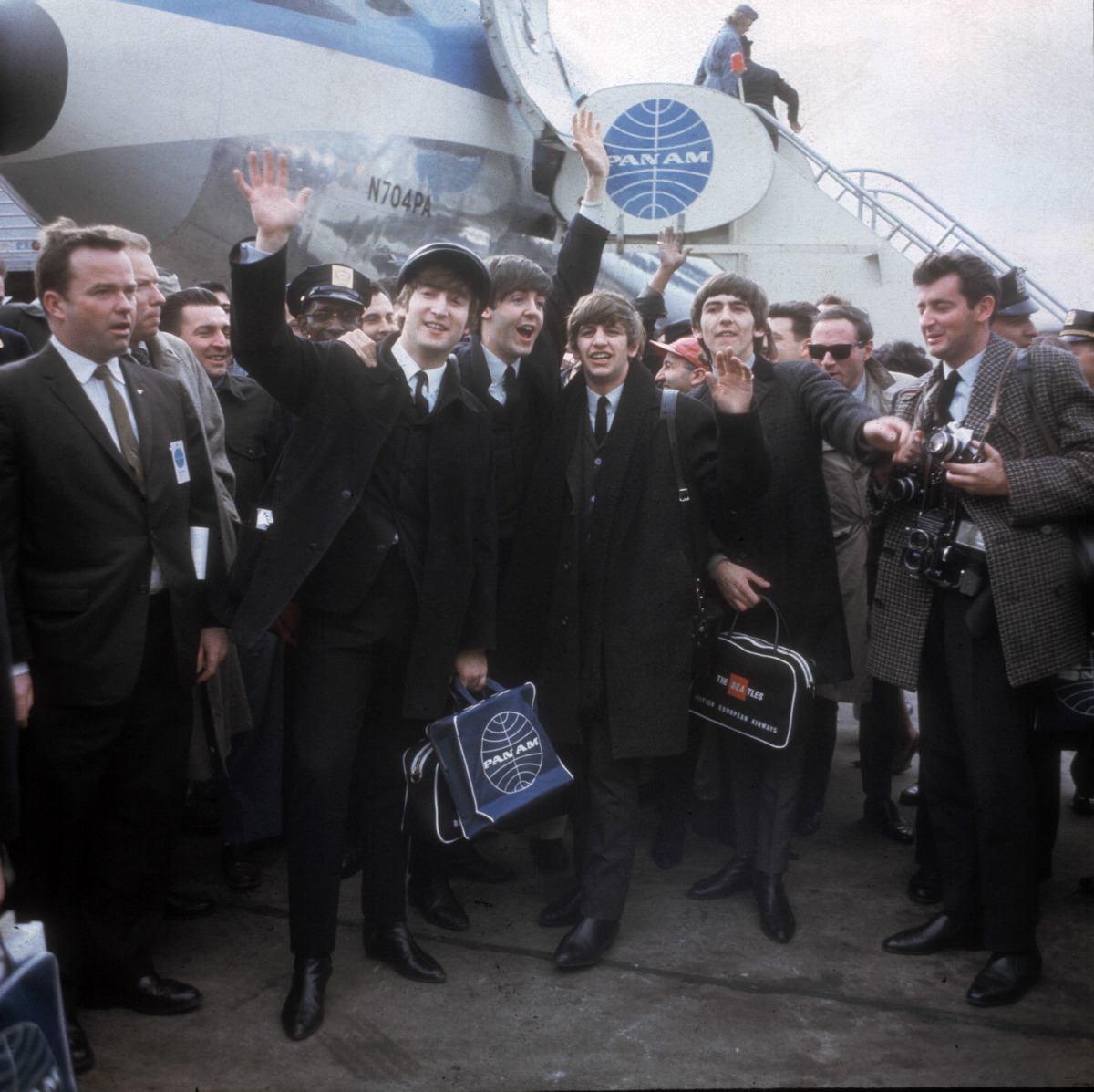 The Beatles arrive at New York's Kennedy Airport Feb. 7, 1964 for their first U.S. appearance. From left are: John Lennon, Paul McCartney, Ringo Starr and George Harrison. Just after 1 p.m. on Feb. 7, 1964, a Pan Am flight from London landed at New York's Idlewild airport. It was carrying a revolution, in the shape of four shaggy-haired musicians from Liverpool. Over the next two weeks The Beatles stormed America, appearing three times on ``The Ed Sullivan Show'' and playing concerts in front of thousands of fervid fans. By the time they flew home, the Fab Four were the most famous band in the world, and the nature of celebrity had changed forever. (AP Photo)
