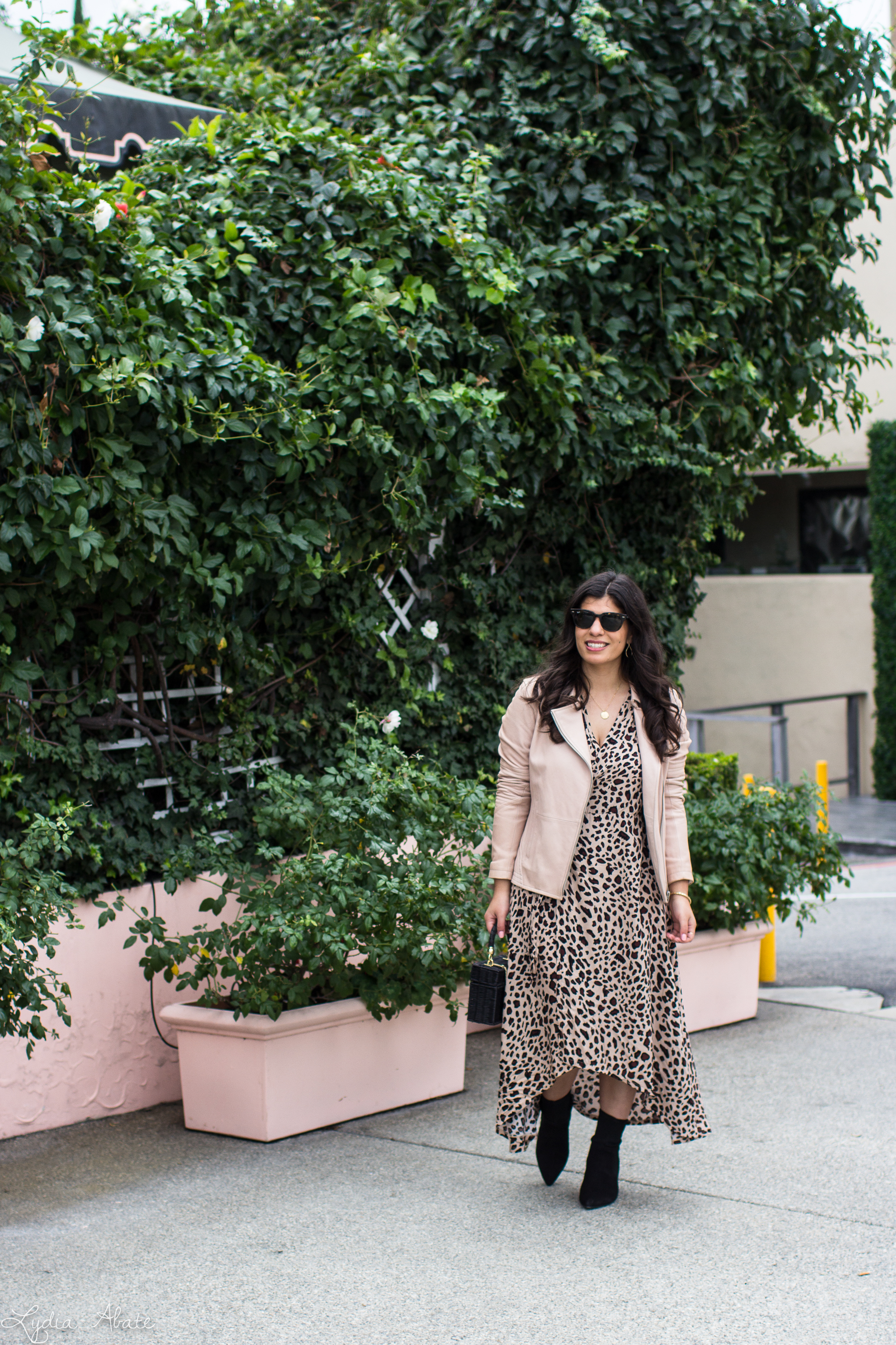 leopard wrap dress, blush leather jacket, black straw bag, sock booties-1.jpg