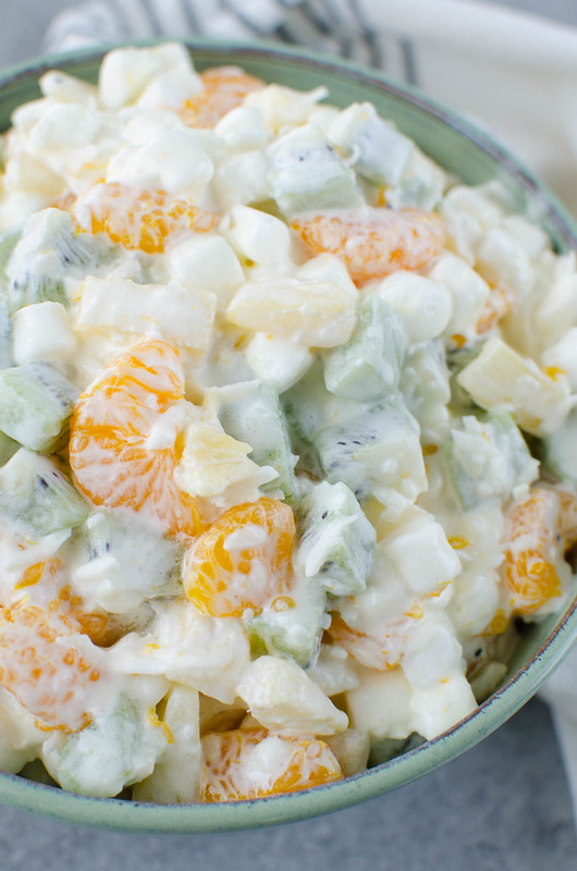Tropical Marshmallow Fruit Salad - mandarin oranges, pineapple, kiwi, coconut, and marshmallow in a sweet and creamy dressing. 