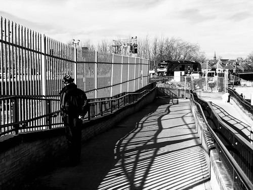 oldman scarboroughbridge 0b65 palisade fencing shadows railing handrails 68031 class68 transpennine express pedestrian waiting exit trilby winter sun