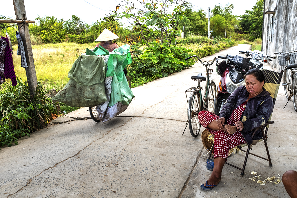 Woman on chair and woman riding a bicycle--Vinh Chau