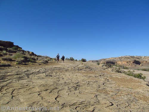 Walking the slickrock that makes up a good portion of the Pueblo Alto Trail, Chaco Culture National Historical Park, New Mexico