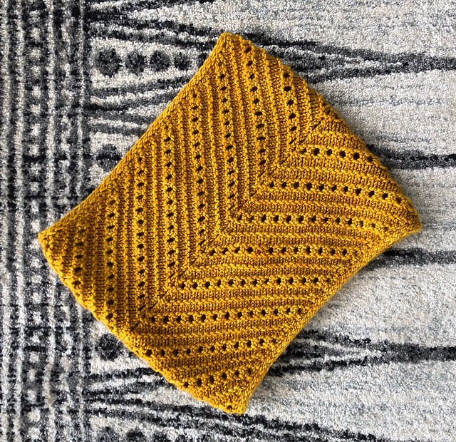 mustard knitted cowl with chevron design and eyelets made from worsted weight yarn