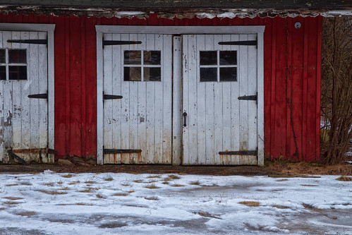 barn doors strap hinges red rural building wooden windows siding newjersey snow cold ice frozen footsteps abandoned