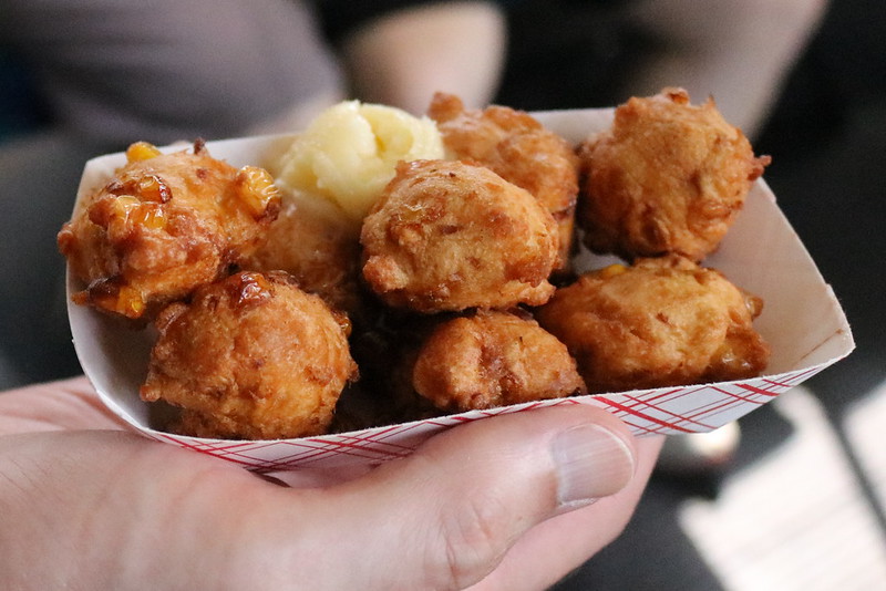 8 small fried dough balls with a scoop of butter.