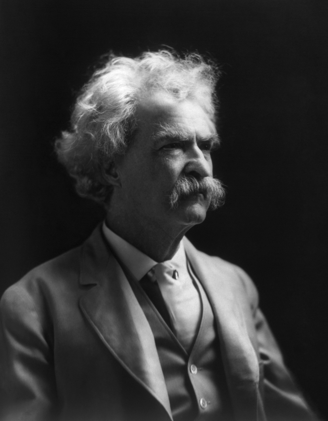 One of a series of photographs of Mark Twain taken by A.F. Bradley for the purpose, arranged by George Wharton James, of helping California poet laureate Ina Coolbrith after she lost her home in the fire following the 1906 San Francisco earthquake. In his New York City studio, Bradley placed Twain on a revolving platform to make the capture of different lighting 