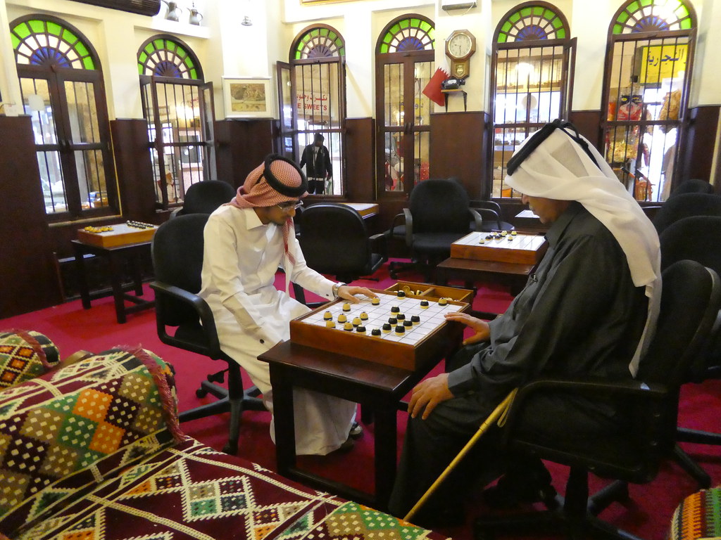 Qatari men enjoying a game of Dama in Souq Waqif, Doha
