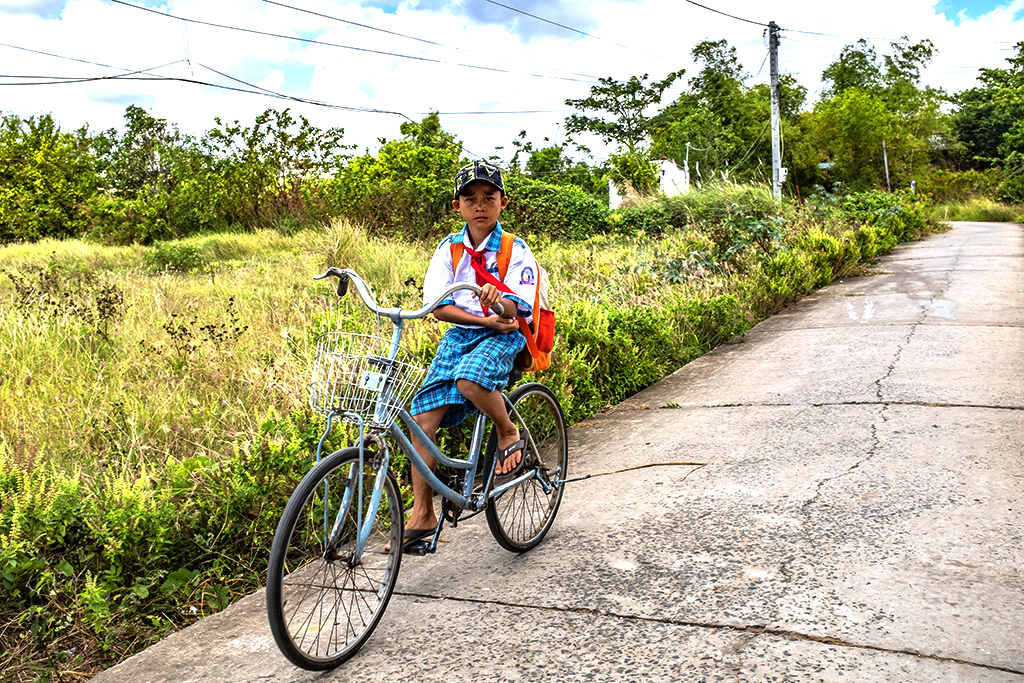 Schoolboy on bicycle--Vinh Chau