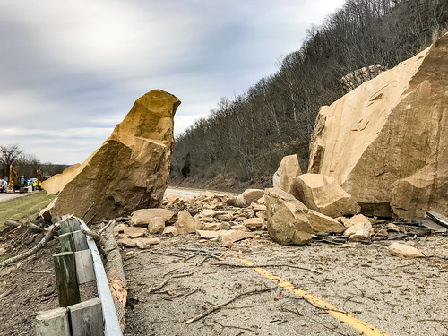 boulder highway slide rock danger guardrail debris mud tan yellow stripe