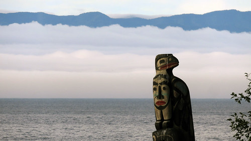 Totem against the fog across the water at Sooke on Vancouver Island, Canada