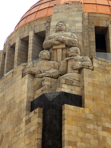 Stalwart figures guard the Monumento a la Revolución in Mexico City