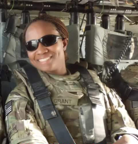 Amber Grant smiles from the cockpit of a helicopter