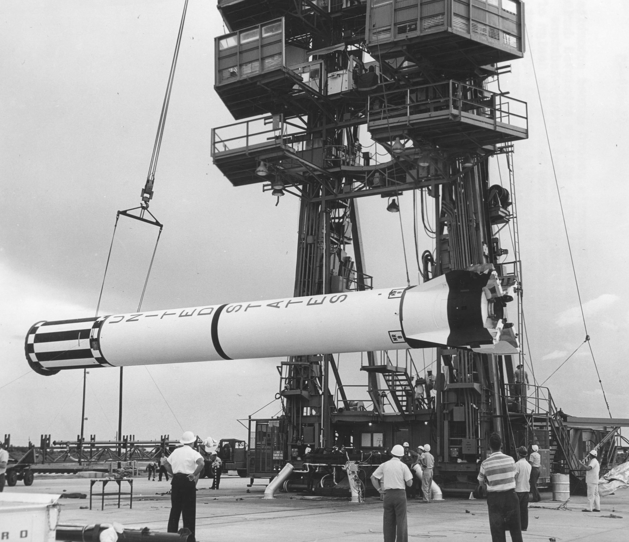 The Mercury-Redstone booster for flight Mercury-Redstone 4 (MR-4) is here being erected on the launch pad in Spring 1961.