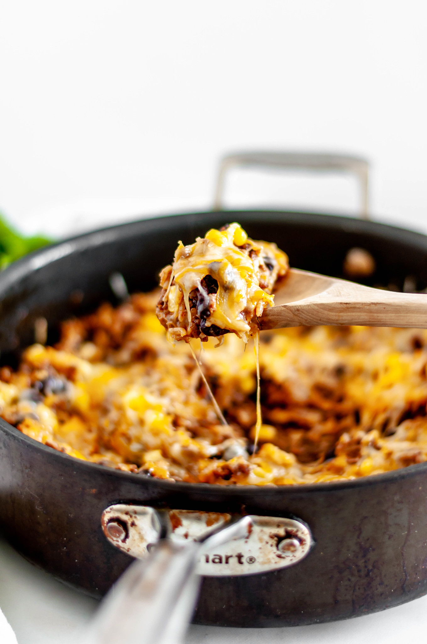This Cheesy Mexican Skillet is done in 30 minutes for the perfect weeknight meal. Packed full of Mexican flavor from enchilada sauce, cumin, chili powder and more.