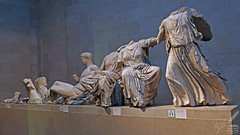 Sculptures displayed at The British Museum in London. They had first been severed and dismembered from the Parthenon (on the Acropolis in Athens) and then they were plundered by Thomas Bruce, 7th Earl of Elgin, in early 19th century.  Lord Elgin abused his position as British Ambassador to the Ottoman Empire to supposedly acquire an alleged Turkish “firman” (permit signed by the occupying Ottoman oppressors’ Sultan) ostensibly allowing him to remove the sculptures. The original firman has never been presented. In any case, issuing such a firman was illicit and illegal (in violation of the Convention for the Protection of Cultural Property in the event of Armed Conflict [art. 5] and also violation of the Hague Convention [ art. 4 & 11]).  Such preposterous, illegal and unethical uprooting of cultural heritage was criticised or censured  by poets, scholars and cultured intellectuals such as Lord Byron. He expressed his undisguised contempt and wrath by including scathing lines in his poems:  ❝Let Aberdeen and Elgin still pursue The shade of fame through regions of Virtù; Waste useless thousands on their Phidian freaks, Misshapen monuments and maimed antiques; And make their grand saloons a general mart For all the mutilated blocks of art:…❞  —Gordon Brown Lord Byron (“English Bards and Scotch Reviewers”).