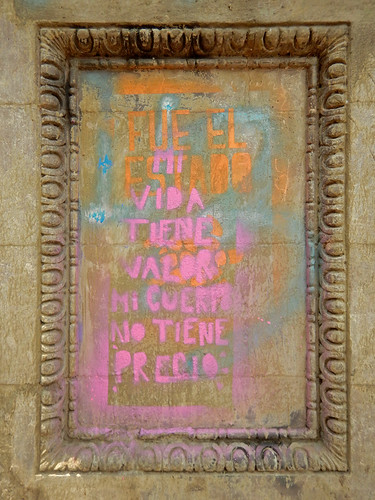 Women protest using pink graffiti on the old stone posts the line the sidewalks of Mexico City