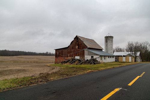 barn building structure historic centerburg ohio unitedstates us outbuilding farm rural road pavement trees field clouds mitchell knoxcounty milfordtownship altered silo metal cladding bank
