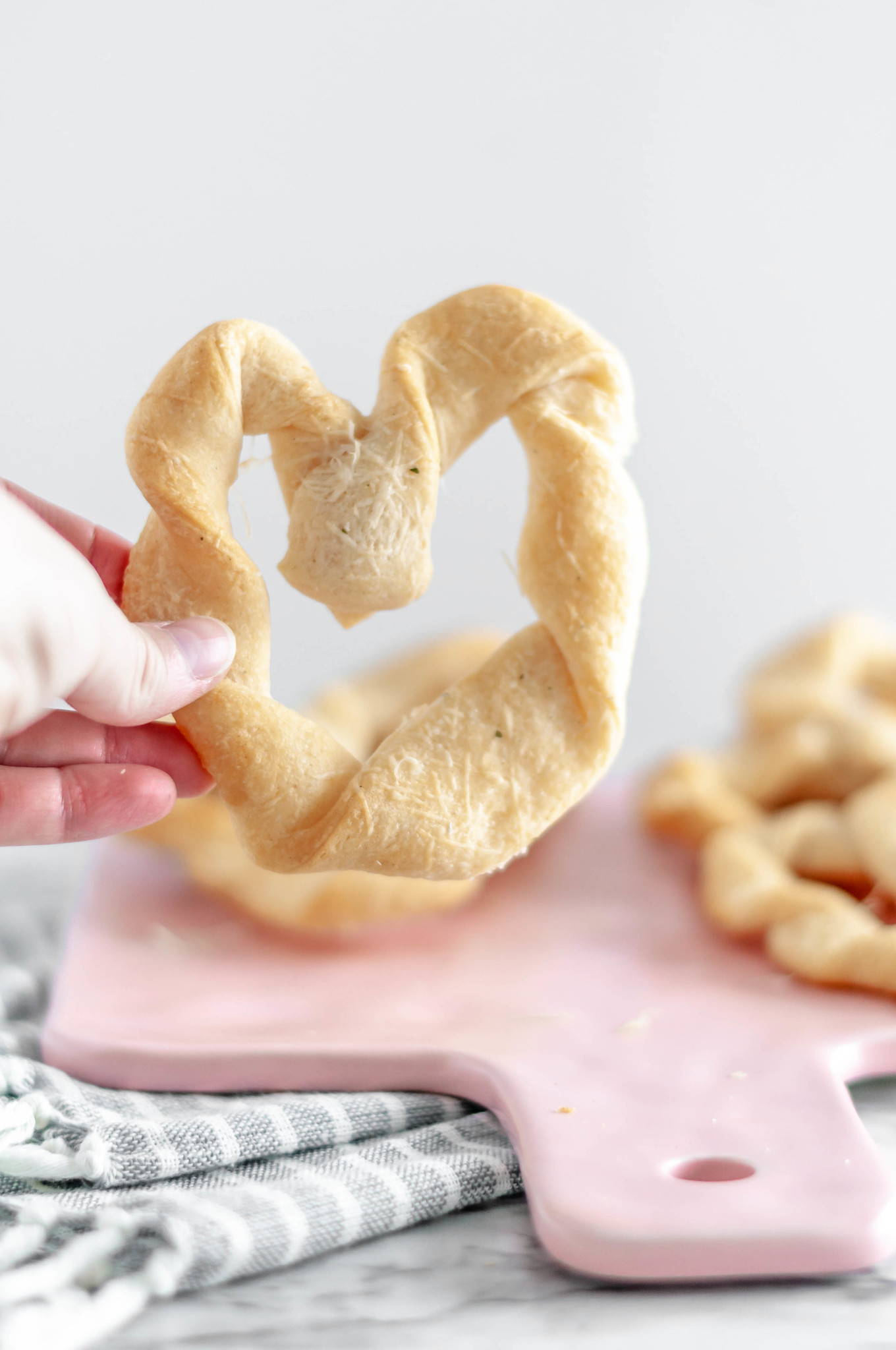 Heart Shaped Breadsticks are a simple way to add some festive flair to Valentines. Store-bought crescent dough & a few simple ingredients are all you need.