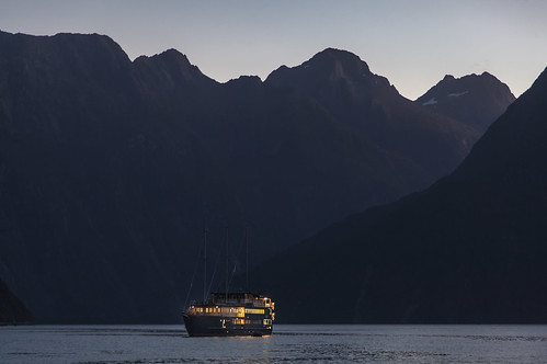boat ship water fiord fjord mountain mountains sky landscape sunset sea pacific milford sound tasman southland newzealand zealand landschaft bluehour blue canon eos canon5d outdoors scenic wild wilderness fiordland